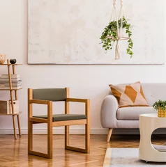 Foto op Plexiglas The modenr boho interior of living room in cozy apartment with design coffee table, gray sofa, wooden cube honey yellow pillow, desk, green armchair, plants and elegant accessories. Modern home decor. © FollowTheFlow