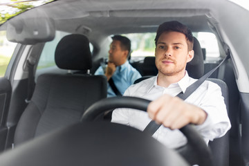 transport, vehicle and people concept - male driver driving car with passenger