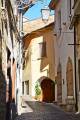 Fototapeta na wymiar Province of Salerno, Italy, 10/21/2017. A narrow road between the old houses of a rural village.