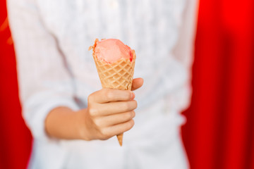 Little beautiful girl eat ice cream outdoors