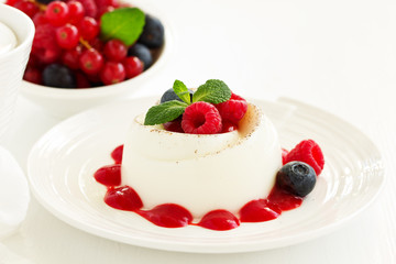 Delicious Italian dessert panna cotta with berries and berry sauce. Valentine's Day.
