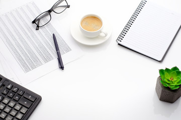 Accounting business concept. Desktop with cup of coffee, calculator, glasses, notepad and spreadsheet.