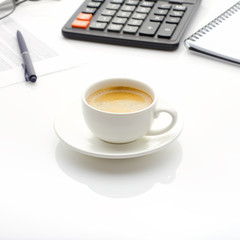 Accounting business concept. Desktop with cup of coffee, calculator, glasses, notepad and spreadsheet.