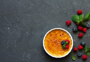 Creme brulee. dessert with caramel crust and berries.