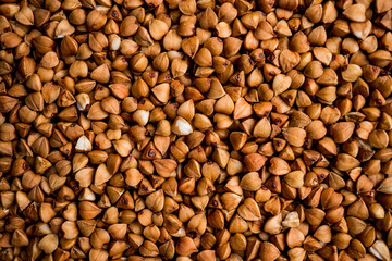 The texture of dry buckwheat. Background image of buckwheat porridge. Maro's Photo