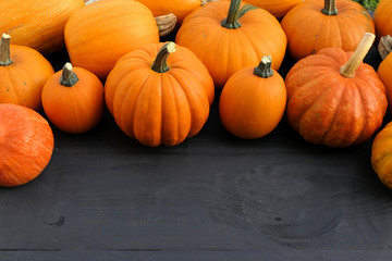 Autumn pumpkins on wooden background.