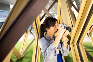 girl photographer In the jean coat take picture at the night with Vintage Film camera