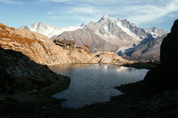 Naklejka na ściany i meble Picturesque view of clear water and mountains reflection on Lac Blanc lake in France Alps. Monte Bianco mountain range on background. Landscape photography, Chamonix.