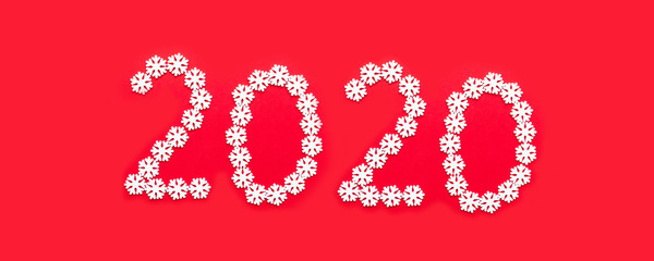Christmas New Year design concept with 2020 numbers made of white snowflakes on a red background.