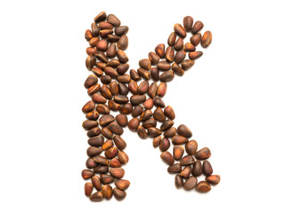 Isolated object: letter lined with ripe pine nuts