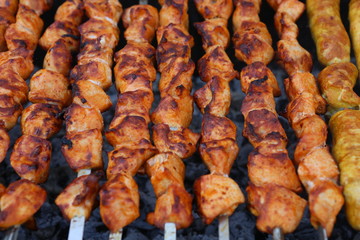 Mixed grilled meat platter. Assorted delicious grilled meat. The closeup of some meat skewers being grilled in a barbecue. grilled meat skewers, barbecue.