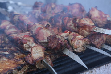 Mixed grilled meat platter. Assorted delicious grilled meat. The closeup of some meat skewers being grilled in a barbecue. grilled meat skewers, barbecue.
