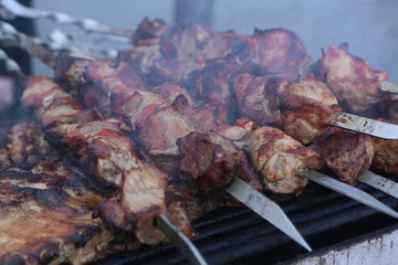 Mixed grilled meat platter. Assorted delicious grilled meat. The closeup of some meat skewers being grilled in a barbecue. grilled meat skewers, barbecue.