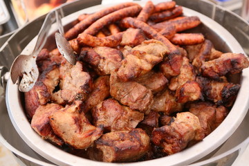 Mixed grilled meat platter. Assorted delicious grilled meat. The closeup of some meat skewers being grilled in a barbecue. grilled meat skewers, barbecue.