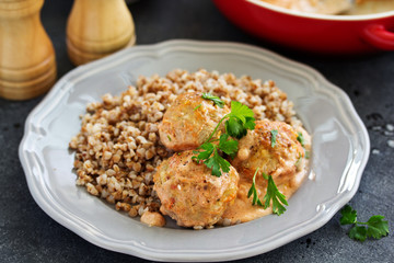 Meatballs in a creamy tomato sauce.