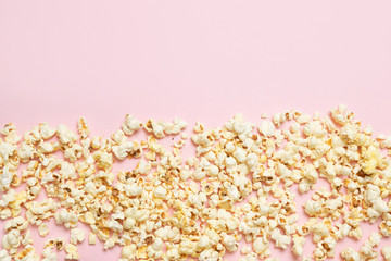 Top view of popcorn pattern on pink background. Cinema, movies and entertainment concept.