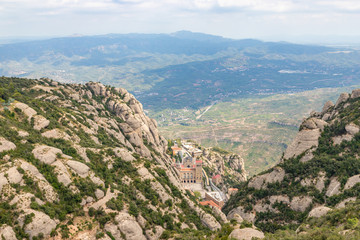 Fototapeta na wymiar Santa Maria de Montserrat Abbey in Monistrol de Montserrat Monastery view from above located nearby from Barcelona in Catalonia, Spain