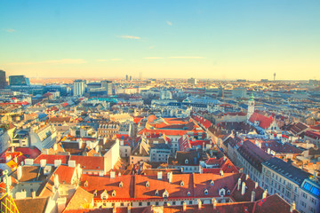 Obraz premium Panoramic view to Stephansplatz and Vienna center, a lot of orange tile roofs. Beautiful bright colors. Vienna, Austria. 