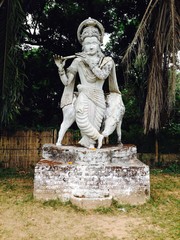 Statue Playing Transverse Flute in Park