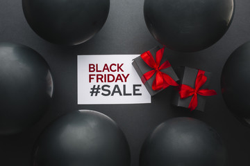 Black friday gifts surrounded by black balloons