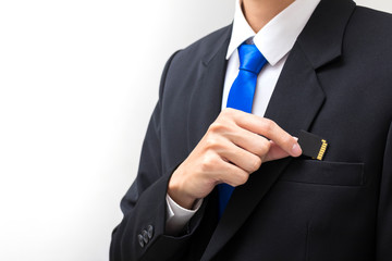 A businessman picks up the memory card from a black suit bag.