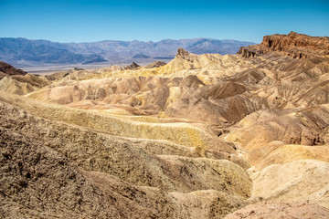 Fototapeta na wymiar Eroding volcanic ash and silt hills, badlands, at Zabriskie Point, Death Valley National Park, California, USA