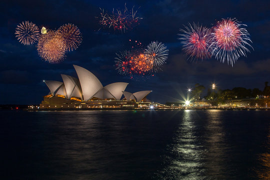 Beautiful fireworks show over the Sydney Opera and Harbour bridge. Celebration concept with massive fireworks display at New Years Eve.