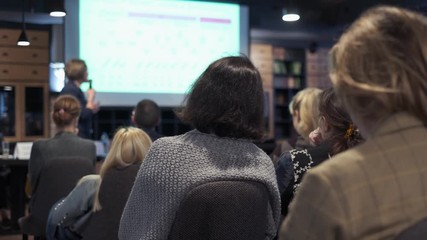 Audience listens lecturer at workshop