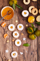 Linzer Christmas cookies with tangerine jam and sugar powder. Delicious biscuits. Sweet dessert. Blank space for text.