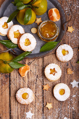 Obraz na płótnie Canvas Linzer Christmas cookies with tangerine jam and sugar powder. Delicious biscuits. Sweet dessert