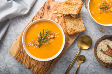 Homemade Autumn Butternut Squash pumpkin cream Soup with Bread and seeds. top view