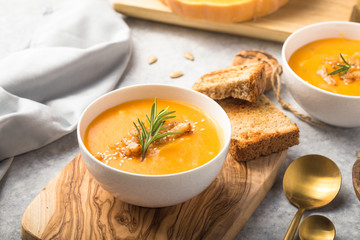 Homemade Autumn Butternut Squash pumpkin cream Soup with Bread and seeds. top view