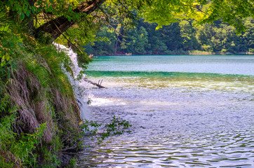 Picturesque landscapes of Plitvice Lakes with waterfalls, mountain rivers, forests and mountains