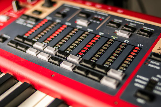 Close-up of a classic red keyboard with keypad and LEDs for hammond sound control