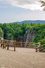 Picturesque landscapes of Plitvice Lakes with waterfalls, mountain rivers, forests and mountains