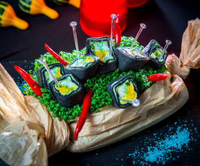 Fototapeta premium Black roll with baked pumpkin, mozzarella cheese and Basil sauce