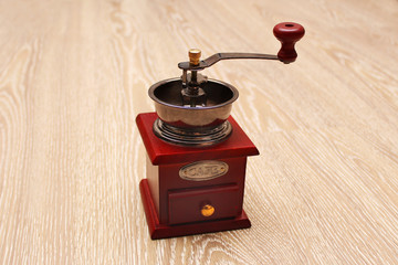 Wooden vintage coffee grinder on a wooden surface
