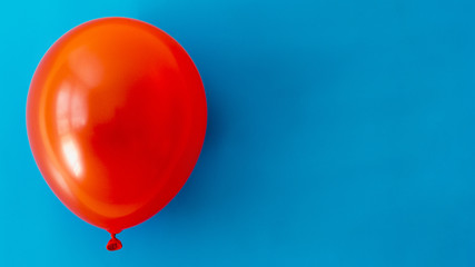Red balloon on blue background with copy space
