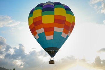 Coroful Hot Air Ballon Flying In The sky with clouds and mountain background