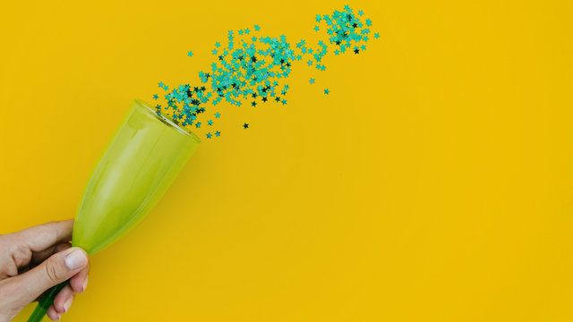 Green Confetti On Yellow Background