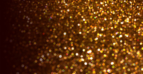 Shining background with shiny sparkling bokeh and magic golden glitter