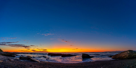 Fototapeta na wymiar Panorama of Sunset at the Rocky Beach