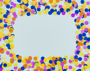 Colourful confetti frame on blue background