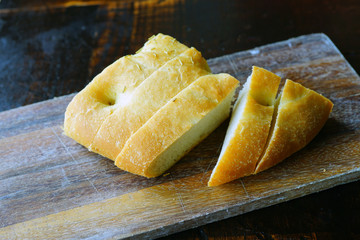 Slices of fresh focaccia bread on a wooden board