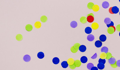 Colorful dots confetti on pink background