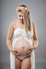 Pregnant young woman studio portrait