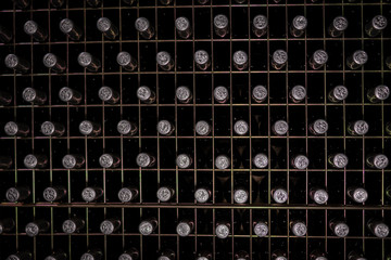 wine bottles stacked in wine cellar