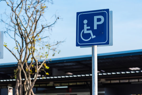 Sign public concept, disabled people parking car sign on pump oil fuel service.