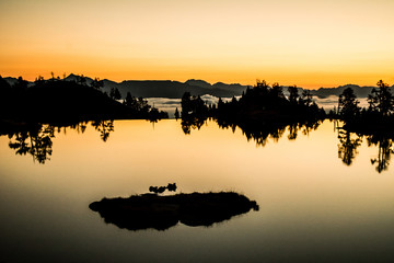 Sunrise lake in the Spanish Pyrenees, located at mountain hut JM Blanc, Aigüestortes i Estany de...