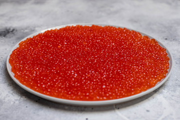 dish with fresh red caviar, close-up. Healthy seafood. light background
